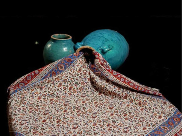 Side-angle shot of a thick cotton tapestry cloth showcasing the texture and vibrant floral ink