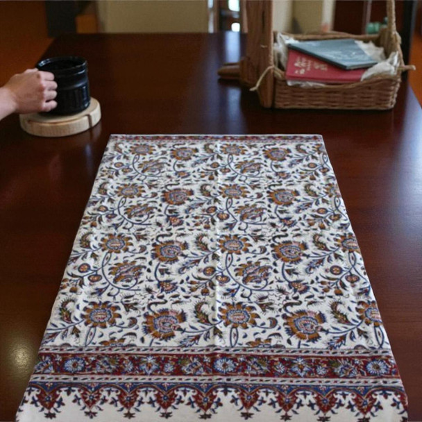 Detailed macro view of the hand-printed floral stamps and delicate vine work on the cotton tapestry
