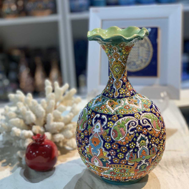 A tall, elegant Persian ceramic vase with turquoise enamel painting and intricate floral patterns