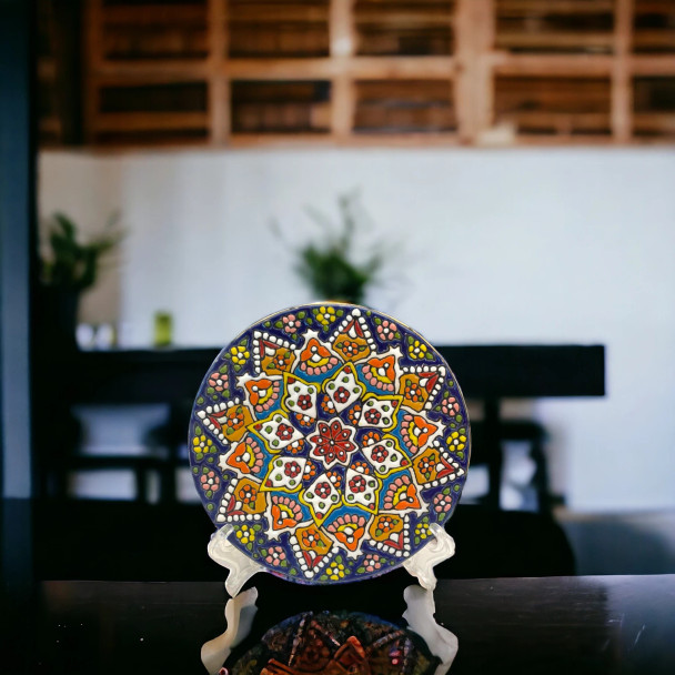 A 15 cm handmade Persian earthenware plate featuring vibrant hand-painted patterns and a brilliant glossy glaze for wall decor.