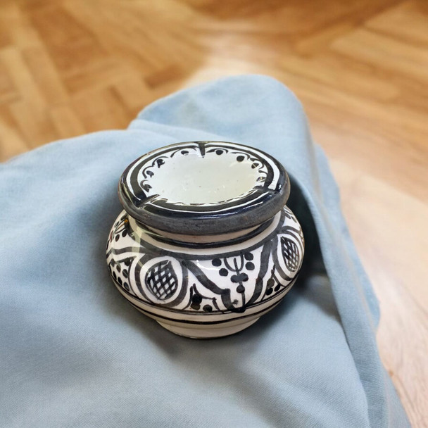 A vibrant cobalt blue and white Moroccan ceramic ashtray with a traditional geometric funnel lid