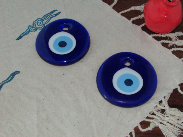 A beautiful set of two glass evil eye charms that combine traditional cultural belief with functional, aesthetic home decor.