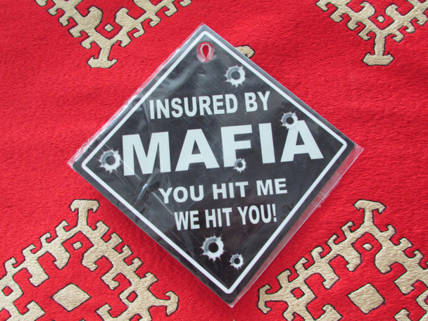 A humorous diamond-shaped "Insured by Mafia" aluminum sign with bullet hole accents