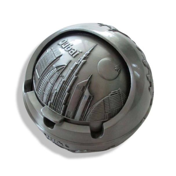 A round 8 cm silver metal ashtray with a secure lid, featuring a high-shine finish and traditional Dubai souvenir motifs.