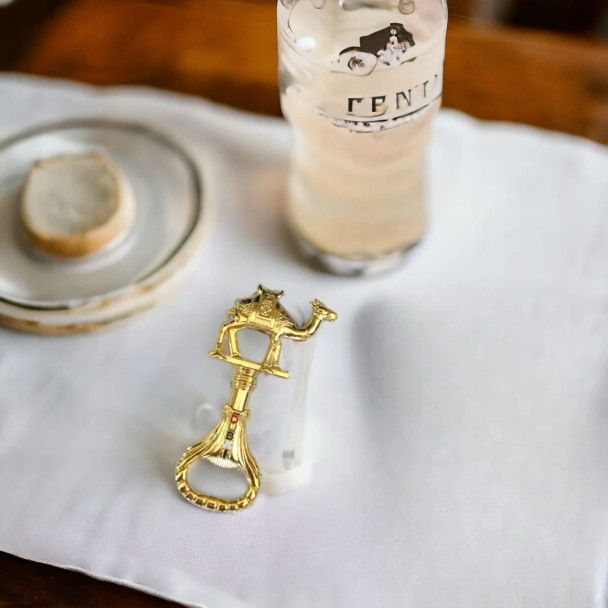 An elegantly designed bottle opener with a traditional camel figure