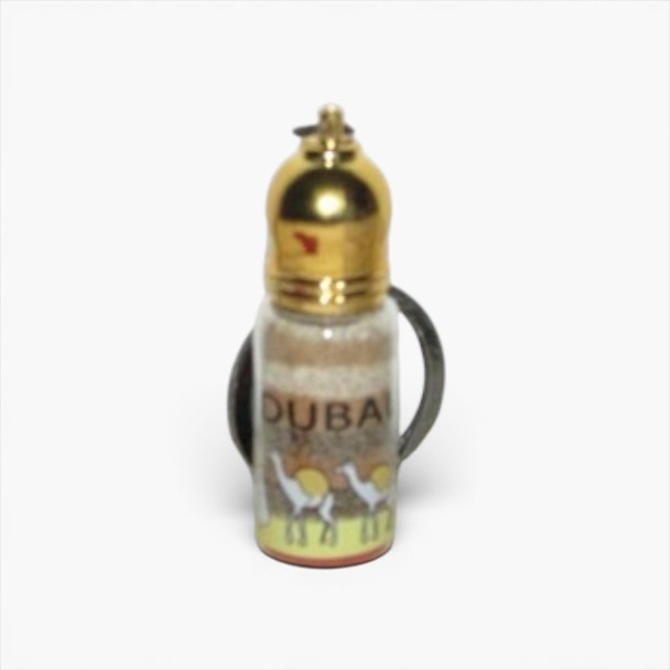 A miniature 5 cm glass sand bottle keychain featuring hand-layered desert sand art and a polished gold-toned cap.
