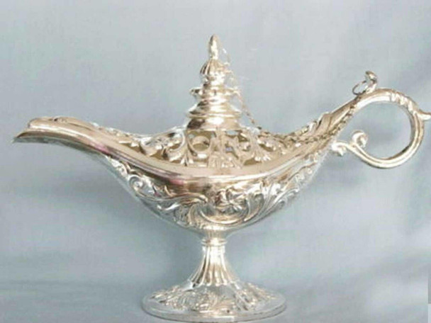 A 12x8 cm silver-colored magic Aladdin lamp souvenir from Dubai with intricate floral relief work.