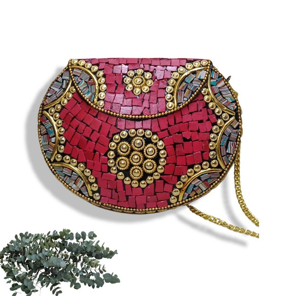 An artisan hard-shell evening clutch covered in mosaic red tiles, accented with gold-tone metallic floral-like motifs and decorative trim.