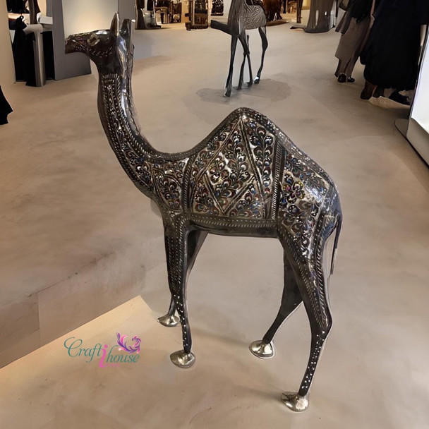 A professionally presented 60 cm handcrafted decorative metal camel sculpture featuring ornate engraved detailing and polished brass accents set against a clean background.