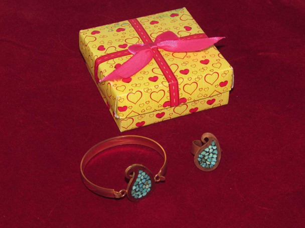 A Cute Handmade Jewelry Set Featuring A Turquoise Inlaid Copper Bracelet And Matching Paisley-Shaped Ring With A Yellow Heart-Patterned Gift Box.