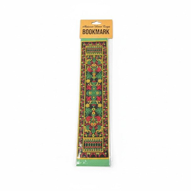 A green miniature woven carpet bookmark featuring a traditional Oriental rug pattern in its retail packaging.