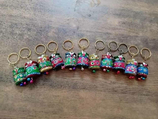 A hand-carved solid wood elephant key chain from India featuring vibrant traditional hand-painted motifs.