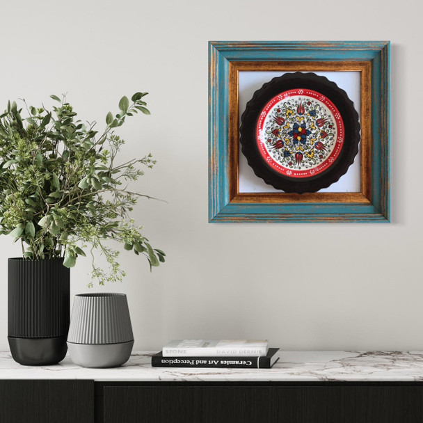 A stunning handmade earthenware plate with intricate hand-painted patterns set in a premium gallery frame for luxury wall decor.