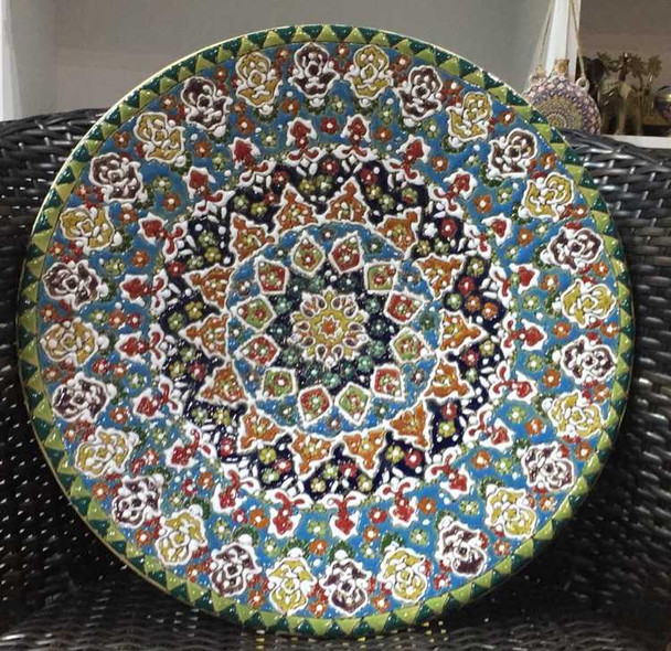 A monumental 40 cm handmade earthenware plate featuring vibrant hand-painted patterns and a food-safe high-gloss glaze.