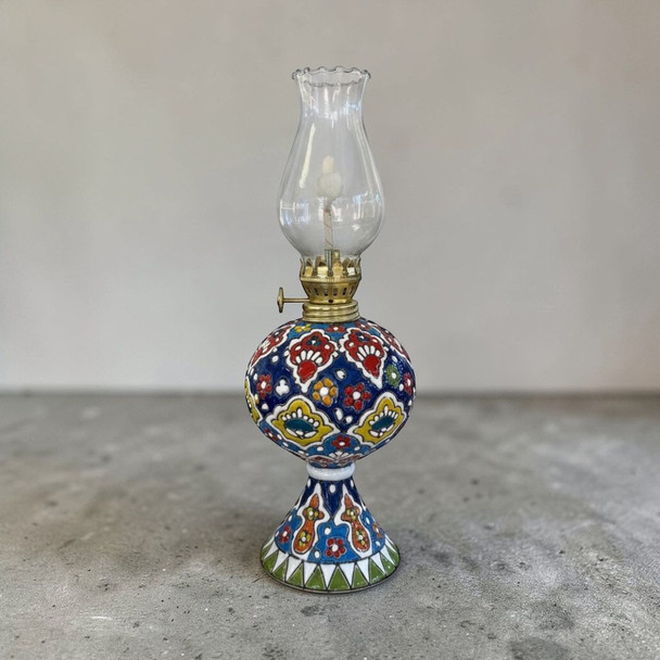 A 25-30 cm hand-enamel painted embossed earthenware kerosene lamp with vibrant colorful patterns.