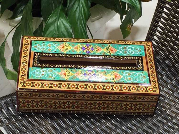 A professional product presentation of the hand-painted Khatamkari wooden tissue box from a premier UAE art, gift, and home decor supplier.