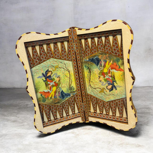 A handmade Persian Khatamkari backgammon set open to show a hand-painted Layla and Majnun miniature painting and geometric mosaic inlay.