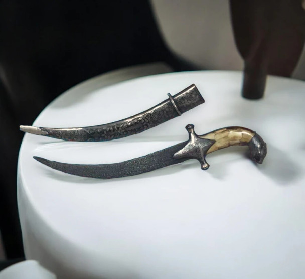 A luxury 42x37cm wooden frame displaying a traditional Khanjar with a hand-carved tiger head camel bone handle.