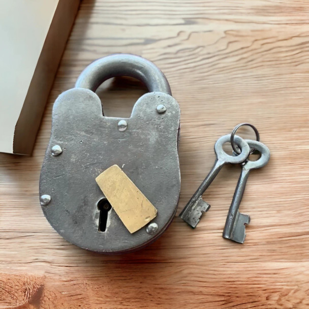 A handcrafted vintage rectangular metal lock with an authentic weathered finish and two skeleton keys.