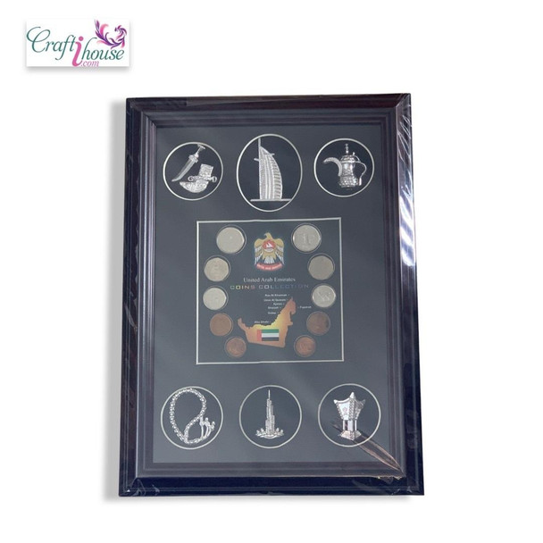 Studio product image of the Craftihouse Emirates coin collection frame with souvenir charms, showcasing the elegant dark wood border framing wrapped in protective film.