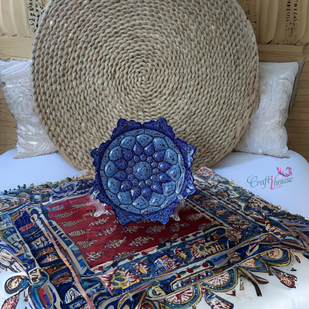 A professional product presentation of the exclusive handmade turquoise and deep blue petal Minakari copper art piece from a premier UAE shop.