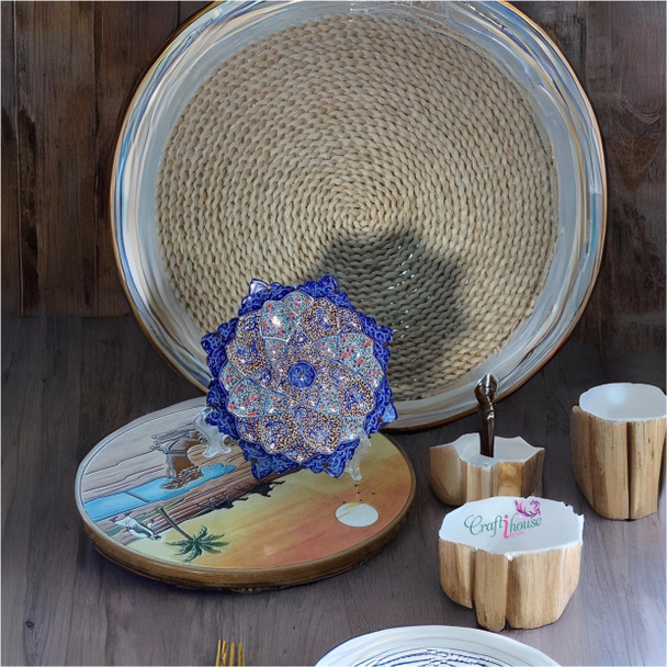 A professional product presentation of the exclusive handmade blue and orange floral Minakari copper art piece from a premier UAE shop.