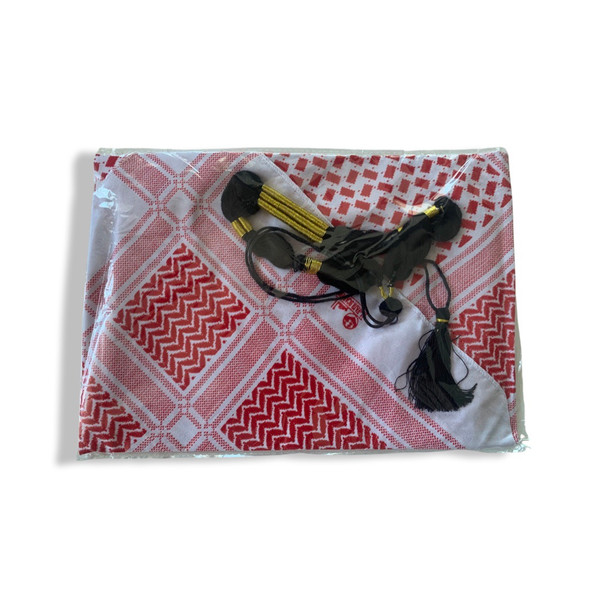 A professional product shot of the packaged ghutra scarf and agal set resting on a neutral white studio background.