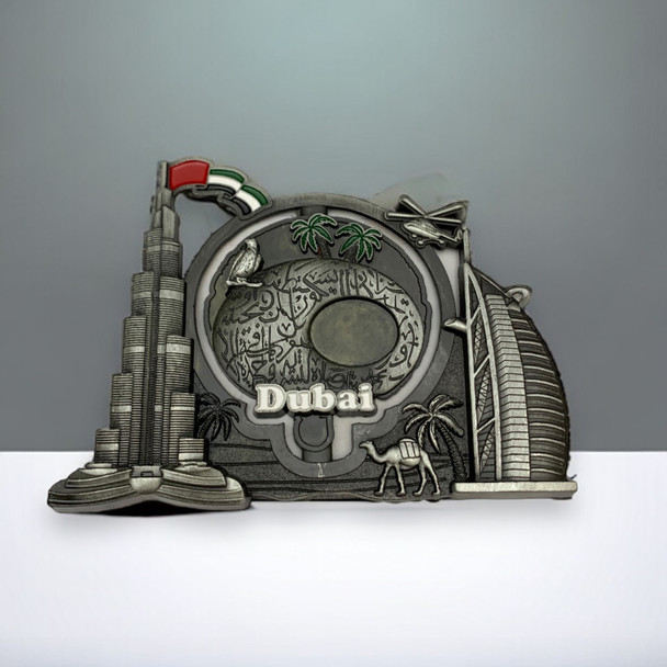 A collectible metal magnet highlighting Dubai's skyline and traditional cultural motifs in a sophisticated silver-tone finish.