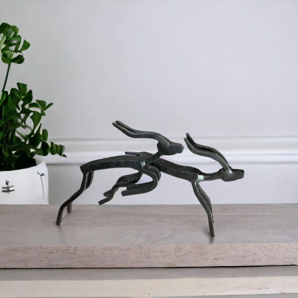 A stylish tabletop metal deer sculpture set showcasing minimalist artistic expression and clean lines.