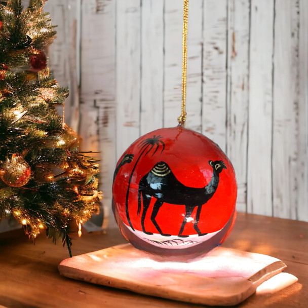 3-inch handmade paper mache decorative ball featuring hand-painted camel artwork and a vibrant red finish.