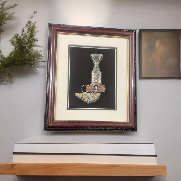 Front exhibition view of an elite traditional Arabian Khanjar dagger presented in a premium shadow box frame as a luxury corporate gift or travel memento.