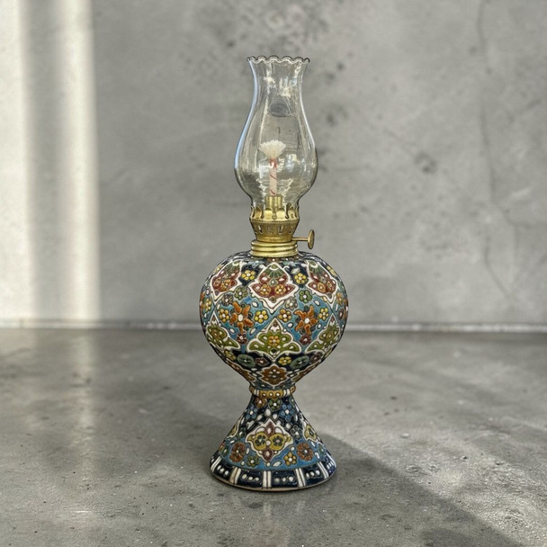 A 30 cm vintage-style hand-enamel painted earthenware kerosene lamp with vibrant, assorted artisan patterns.
