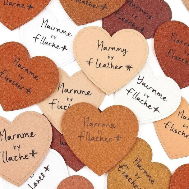 Collection of heart-shaped faux leather tags in various pastel colors with custom personalized text.