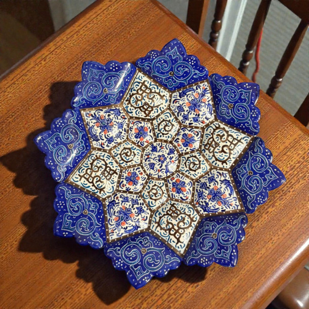 A professional product presentation of the exclusive handmade starburst filigree Minakari copper art piece from a premier UAE shop.