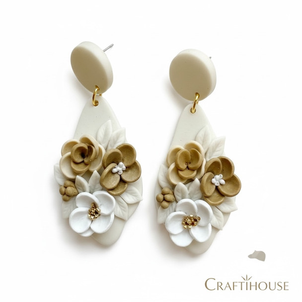 A pair of handcrafted off-white clay teardrop earrings featuring 3D sculpted flowers in mocha brown, tan, and white with cream leaves.