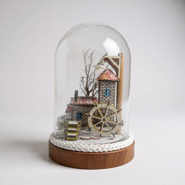 A 17cm tall glass dome featuring a handcrafted miniature watermill with a snow-covered landscape and a wooden base.