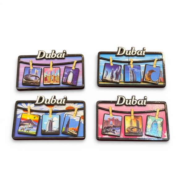 A complete set of four rectangular wooden fridge magnets featuring different colored backgrounds and iconic Dubai landmark photos.