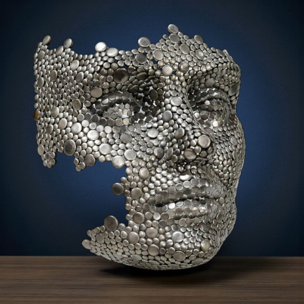 A 55 cm tall industrial sculpture of a human face made from hundreds of hand-welded metal discs against a white background.
