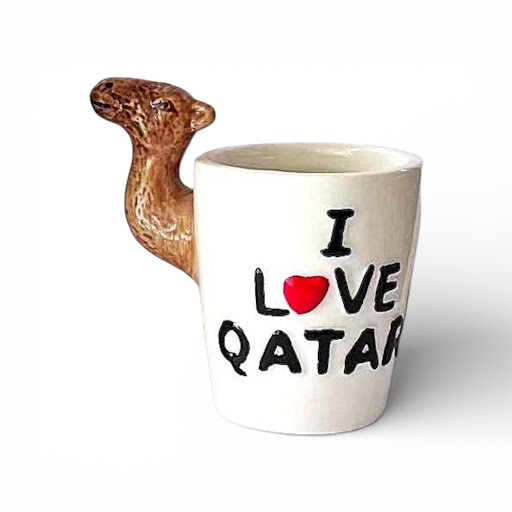 A white ceramic mug with 'I Love Qatar' text and a red heart, featuring a realistic 3D sculpted camel head as a handle.