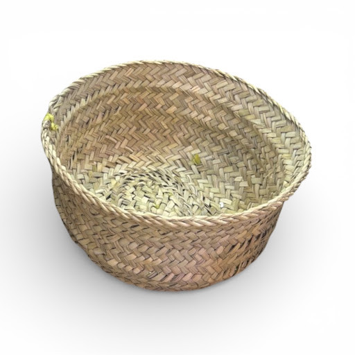 A top-down view of a round 30 cm basket hand-woven from natural date palm leaves.