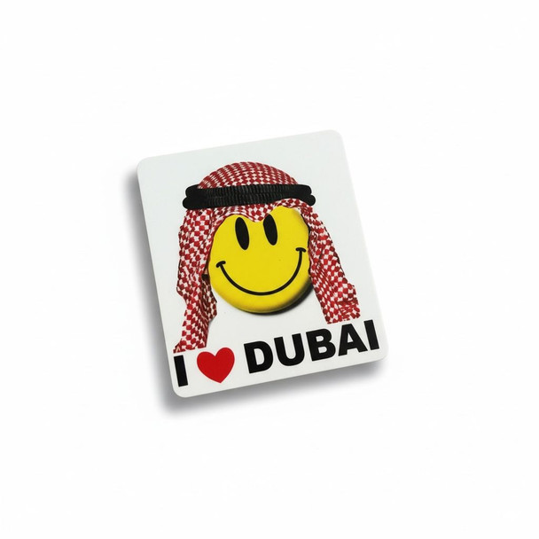 A 5×4.5 cm aluminum fridge magnet featuring a smiling Arab man emoji and the "I Love Dubai" message.