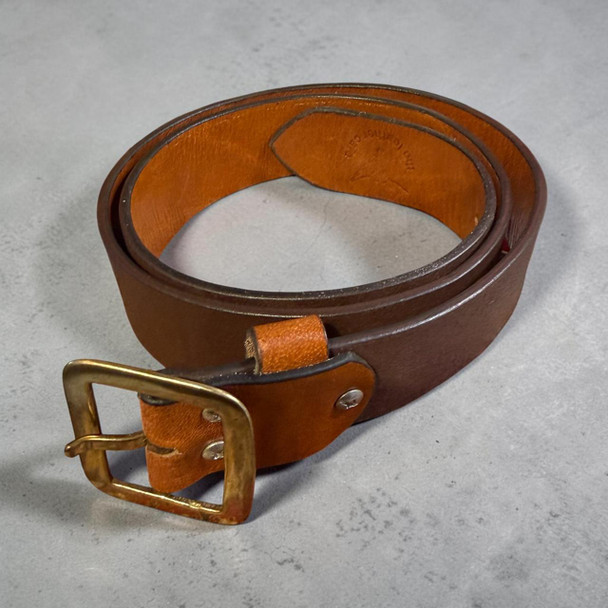 A premium handmade natural leather belt in deep brown featuring a sleek gunmetal-tone buckle, perfect as a gift for him.