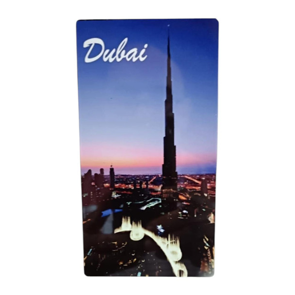 A 14x8 cm vertical aluminum magnet featuring the illuminated Burj Khalifa tower against a dusk sky, with the "Dubai" label at the top.