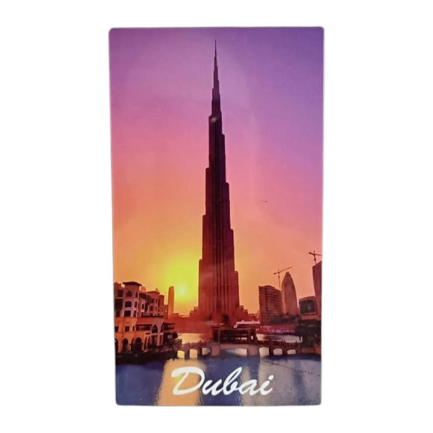 A 14x8 cm vertical aluminum magnet showing the Burj Khalifa during a golden sunset, reflected in the waterfront, with "Dubai" text at the bottom.