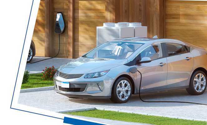 silver car parked in front of a home with charger attached