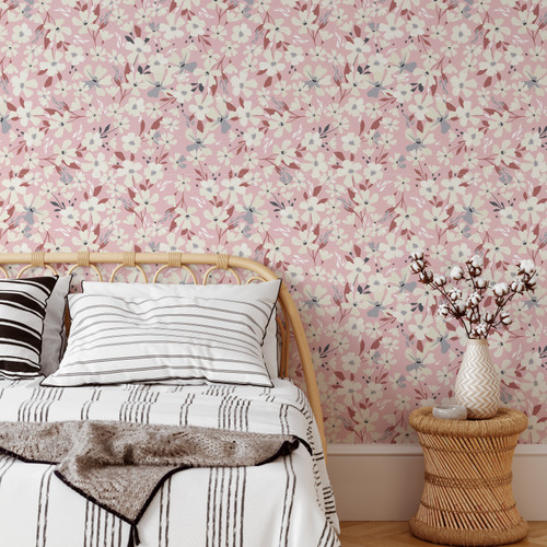 A gorgeously delicate and ditsy floral wallpaper with blossom petals set against a pink background. Great for a bedroom or living room feature wall.