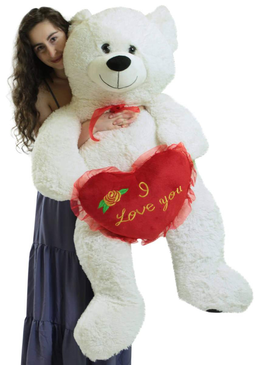 white teddy bear holding a heart