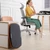 Home office setup showing the balance board neatly stored upright beside an office chair and desk