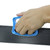 Handheld demonstration shot showing a technician gripping and sliding the XCMAN edge tuner tool along a snowboard edge