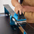 Workshop view demonstrating the XCMAN waxing iron gliding smoothly along the edge of a ski base